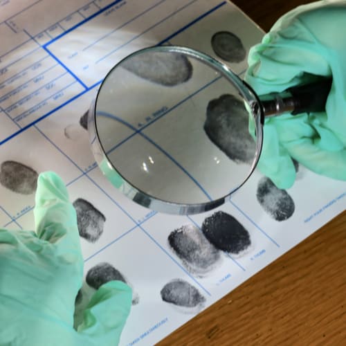 Investigator examining fingerprints 