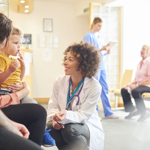 Family nurse practitioner talking with patients