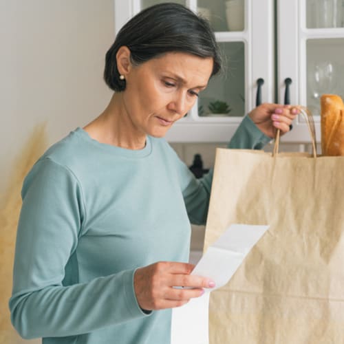 woman looking at grocery list