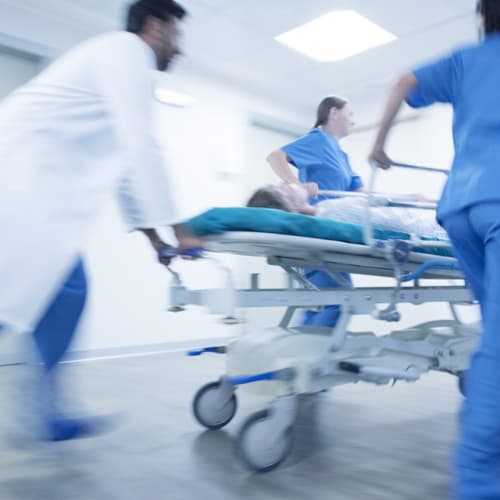 ER nurses and doctor with patient on stretcher