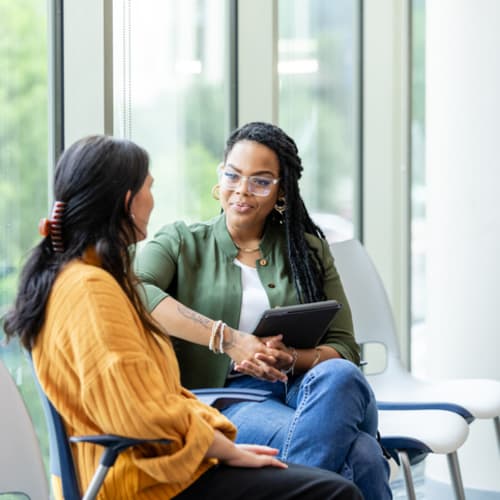 Doctoral student sitting with professor