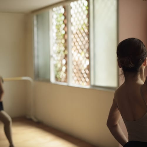 Ballerina exercising in studio - stock photo