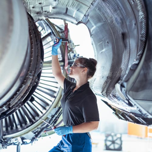 woman engineer examining an airplane wing