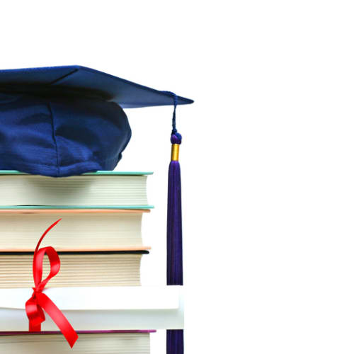 graduation cap on top of books and a diploma