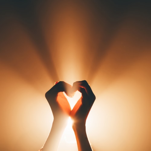 A symbolic image of faith, love and platonic pleasures. Hands forming a heart shape - stock photo