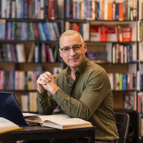 Male doctoral student studying in library