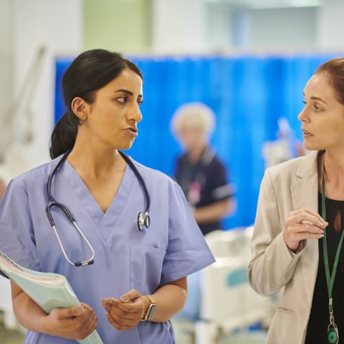 Two colleagues discuss hospital affairs.
