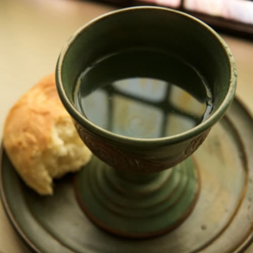 Communion bread and wine sitting on a window sill