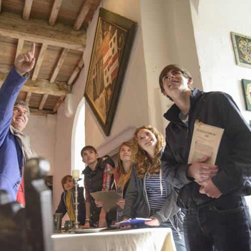 Male tour guide with a group of young tourists