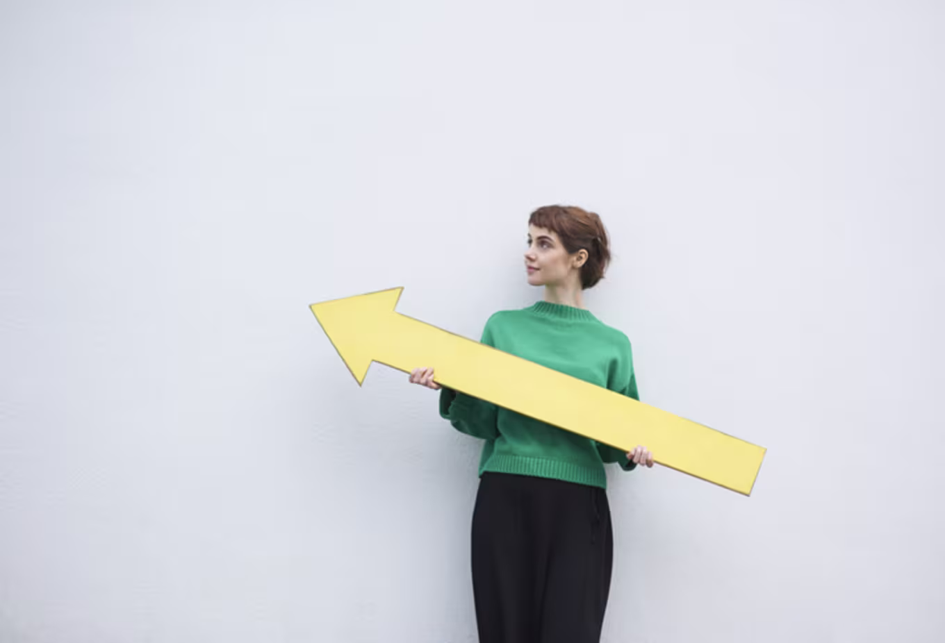 woman holding arrow upward