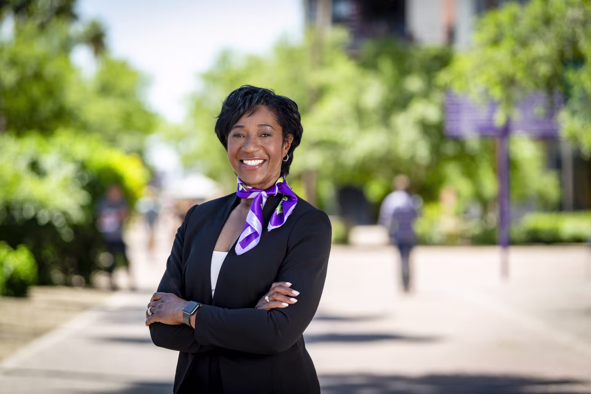 HR faculty member wearing black suit with purple scarf