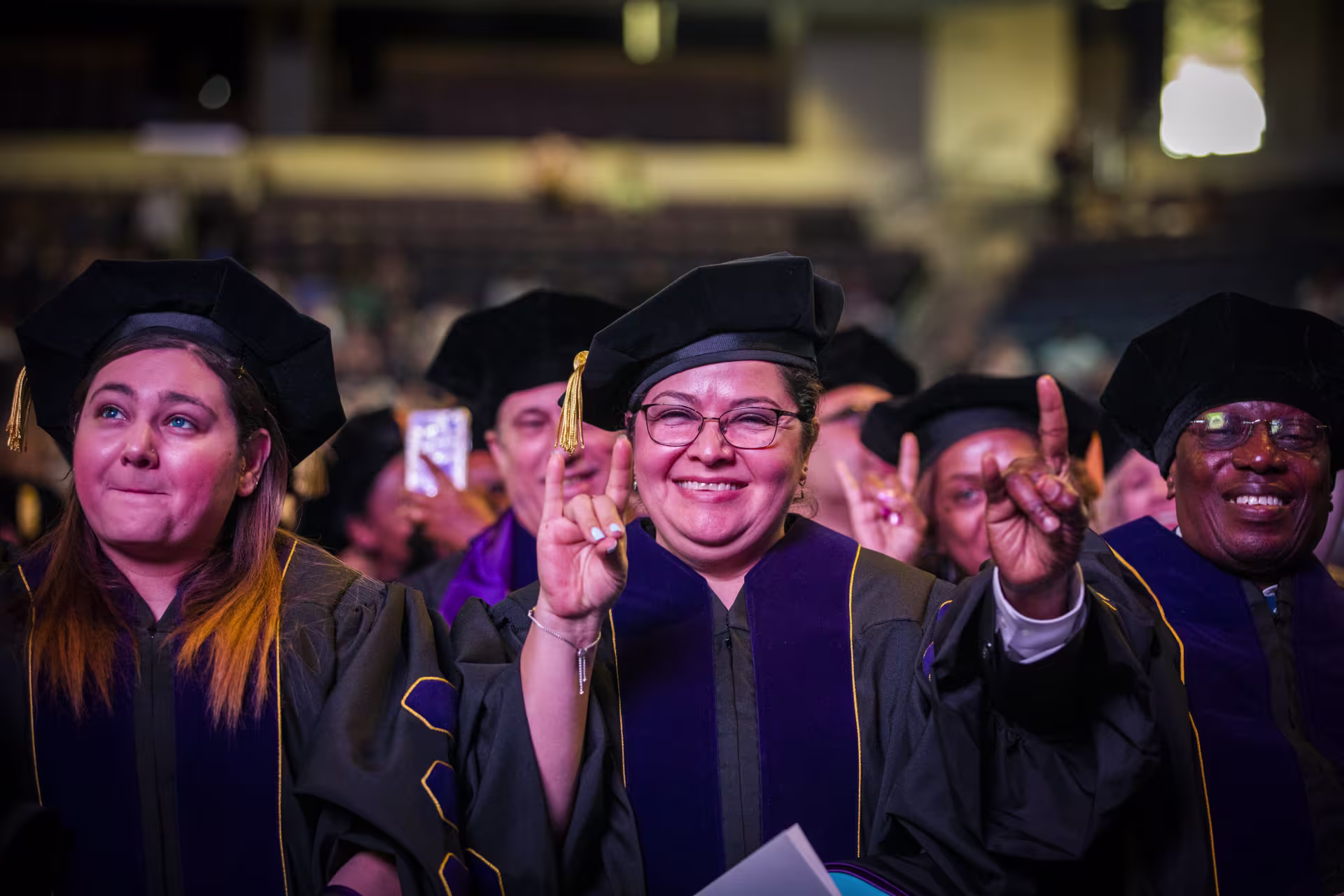 Group of DBA degree graduates in caps and gowns at GCU commencement