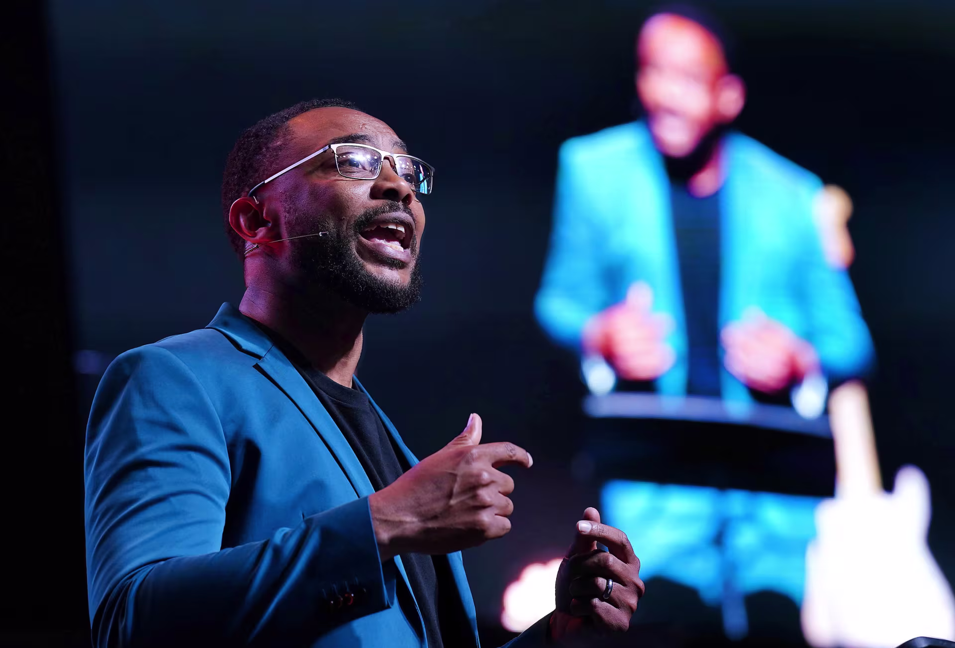 Sports manager talking on stage