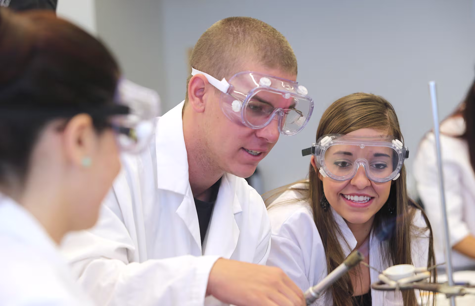 Pre-pharmacy teacher working with students in a labratory