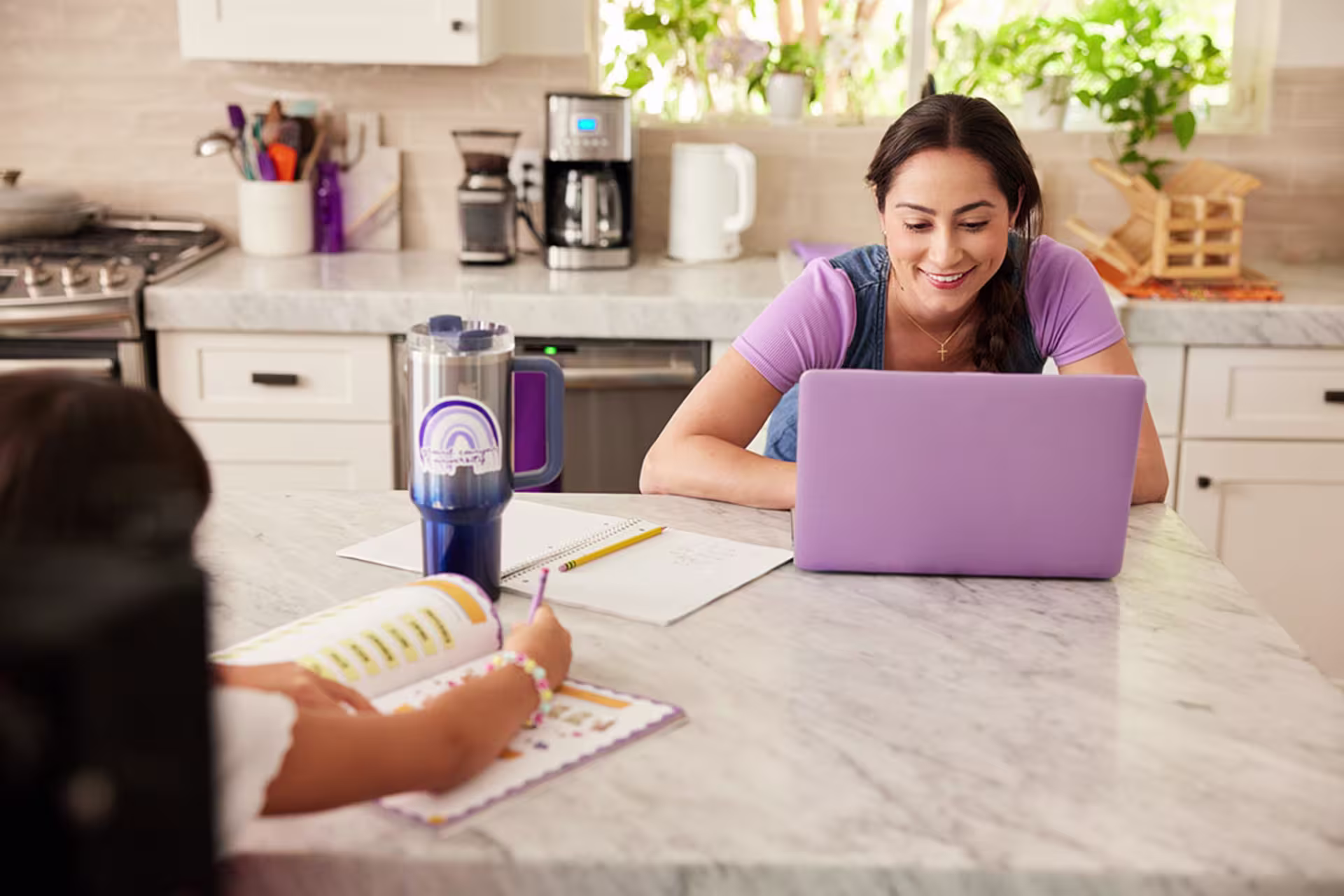 Female healthcare student studying on laptop at home
