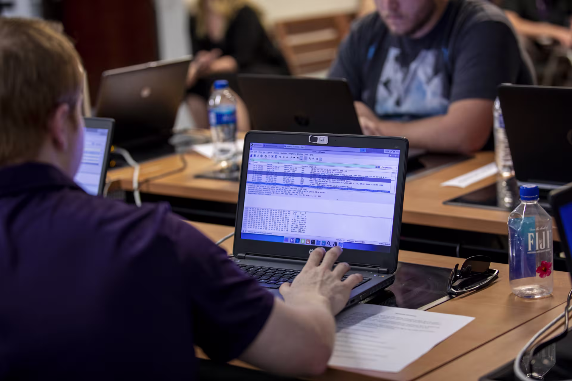 male student developing software in lab.