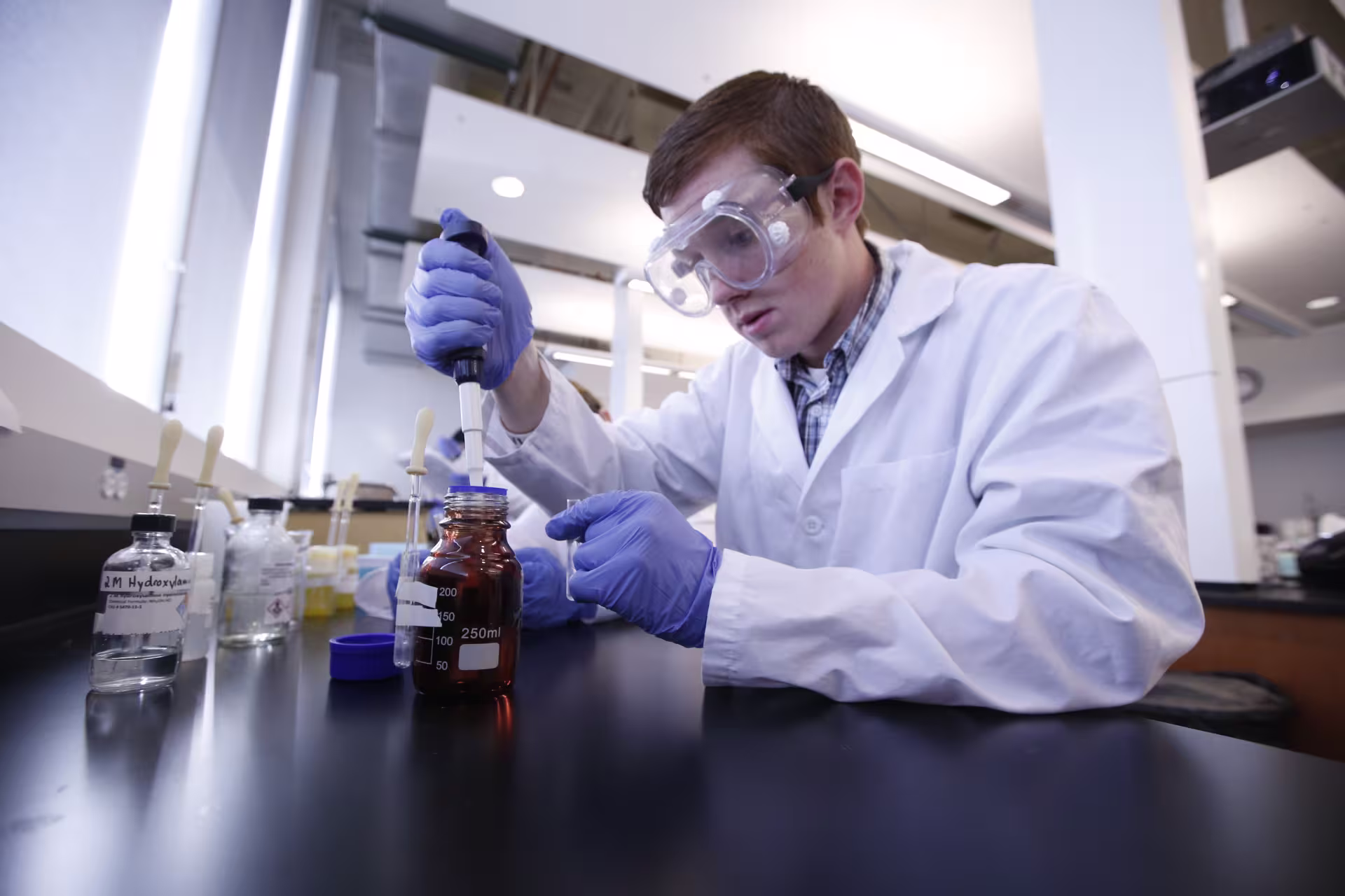 Pre-pharmacy student working with lab equipment