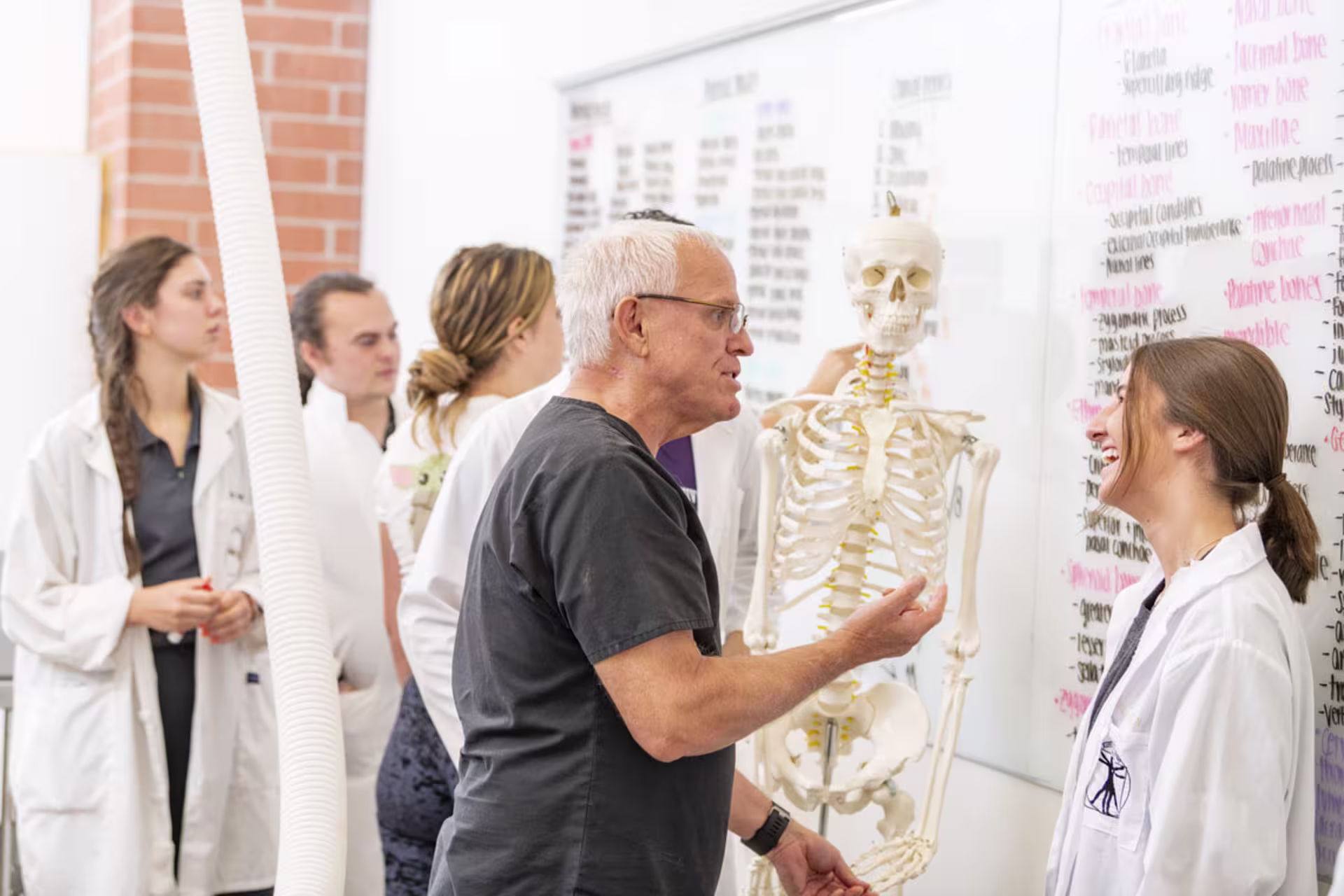 Students and biology professionals collaborating at a lab