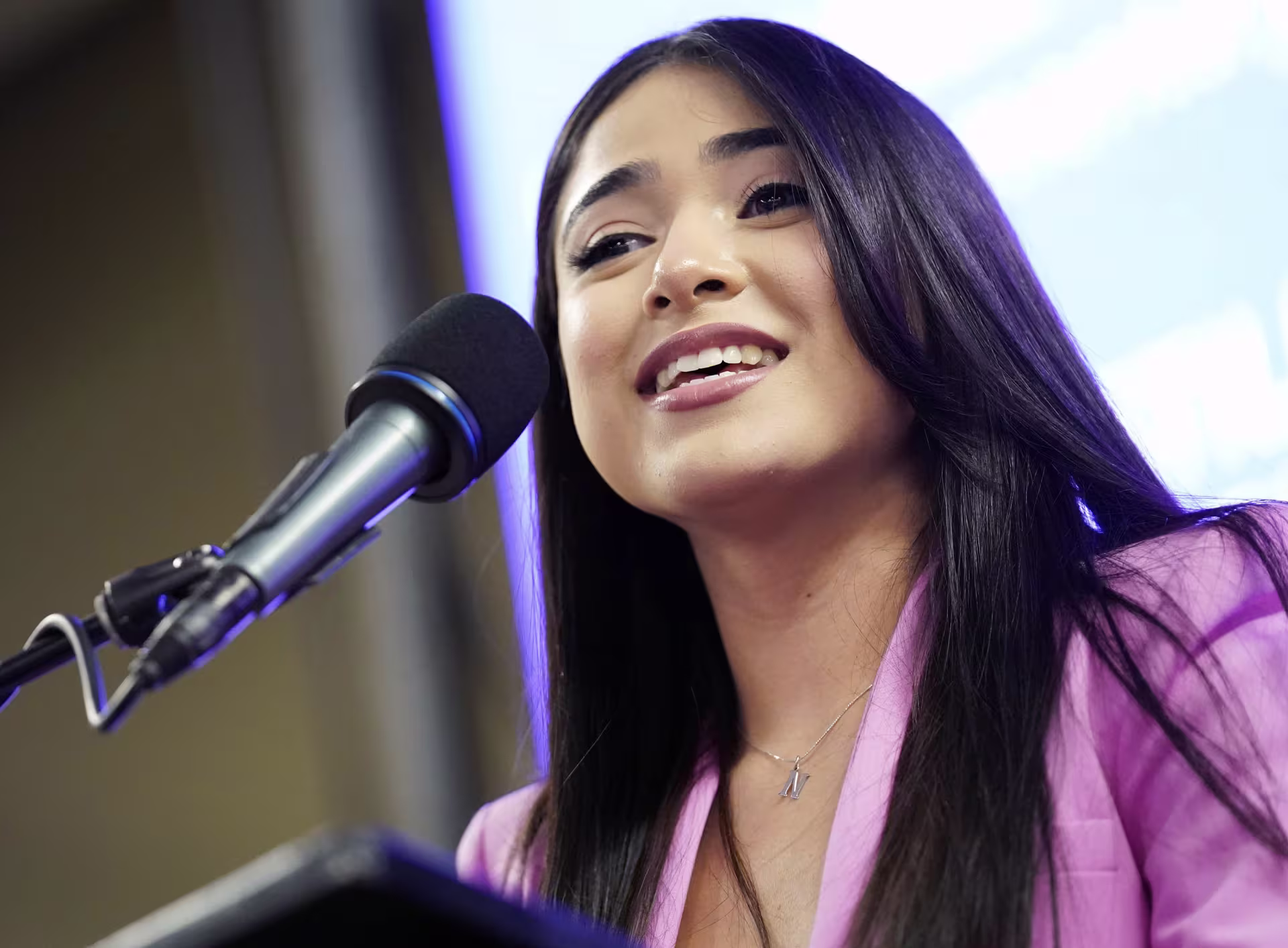 Woman speaking into microphone
