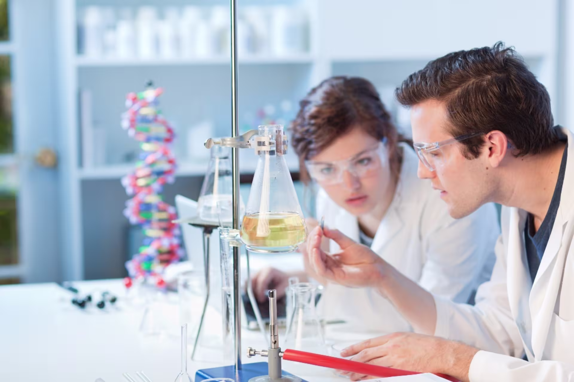 Chemistry students observing beaker in lab setting