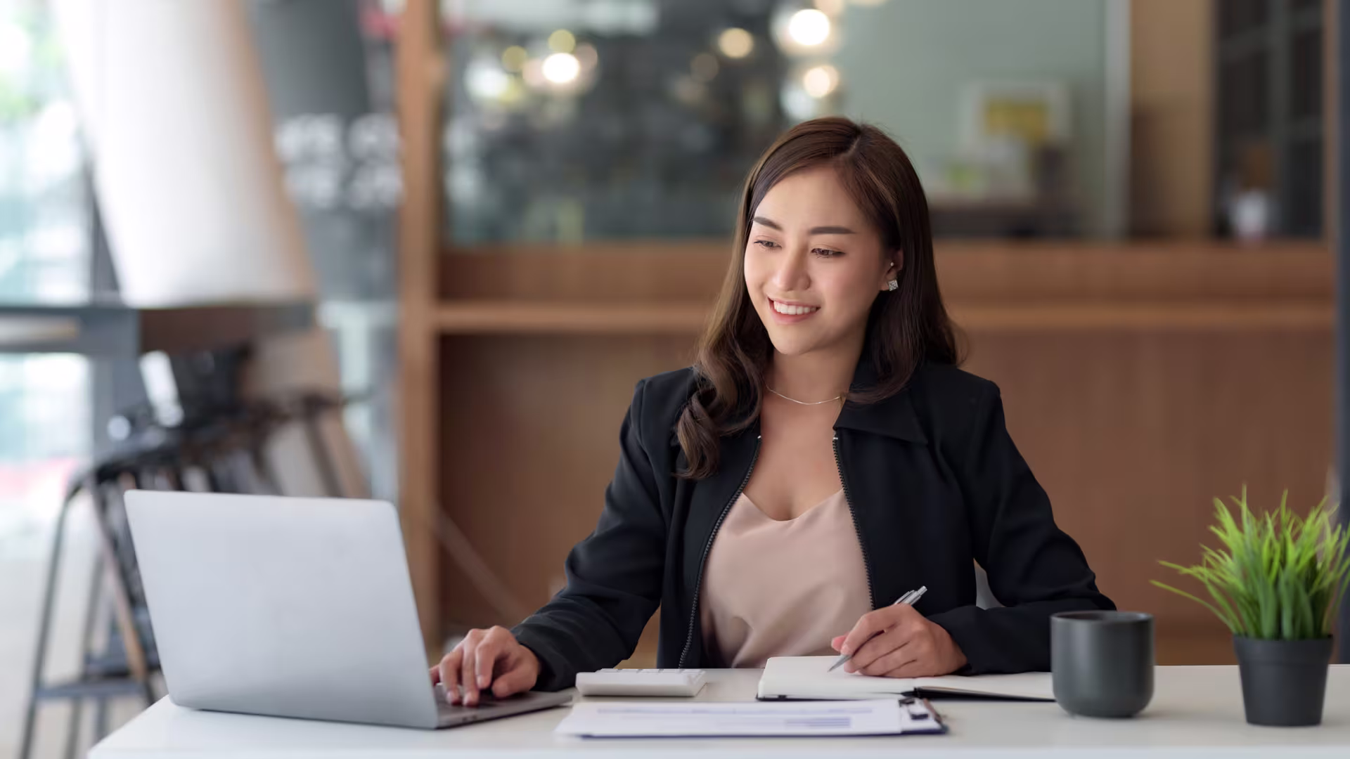 female-finance-professional-on-laptop-at-desk