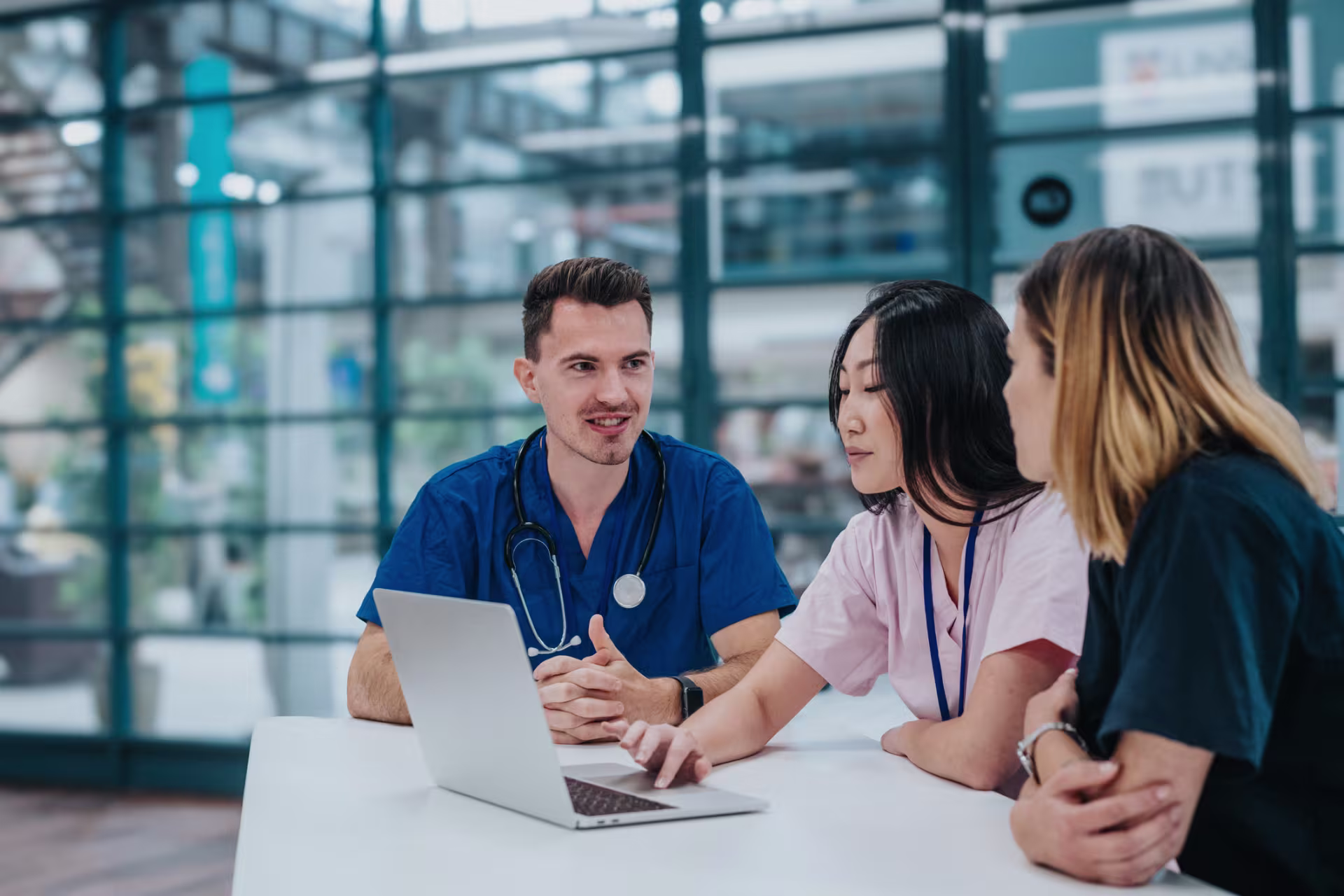 group-of-health-care-professionals-looking-at-laptop