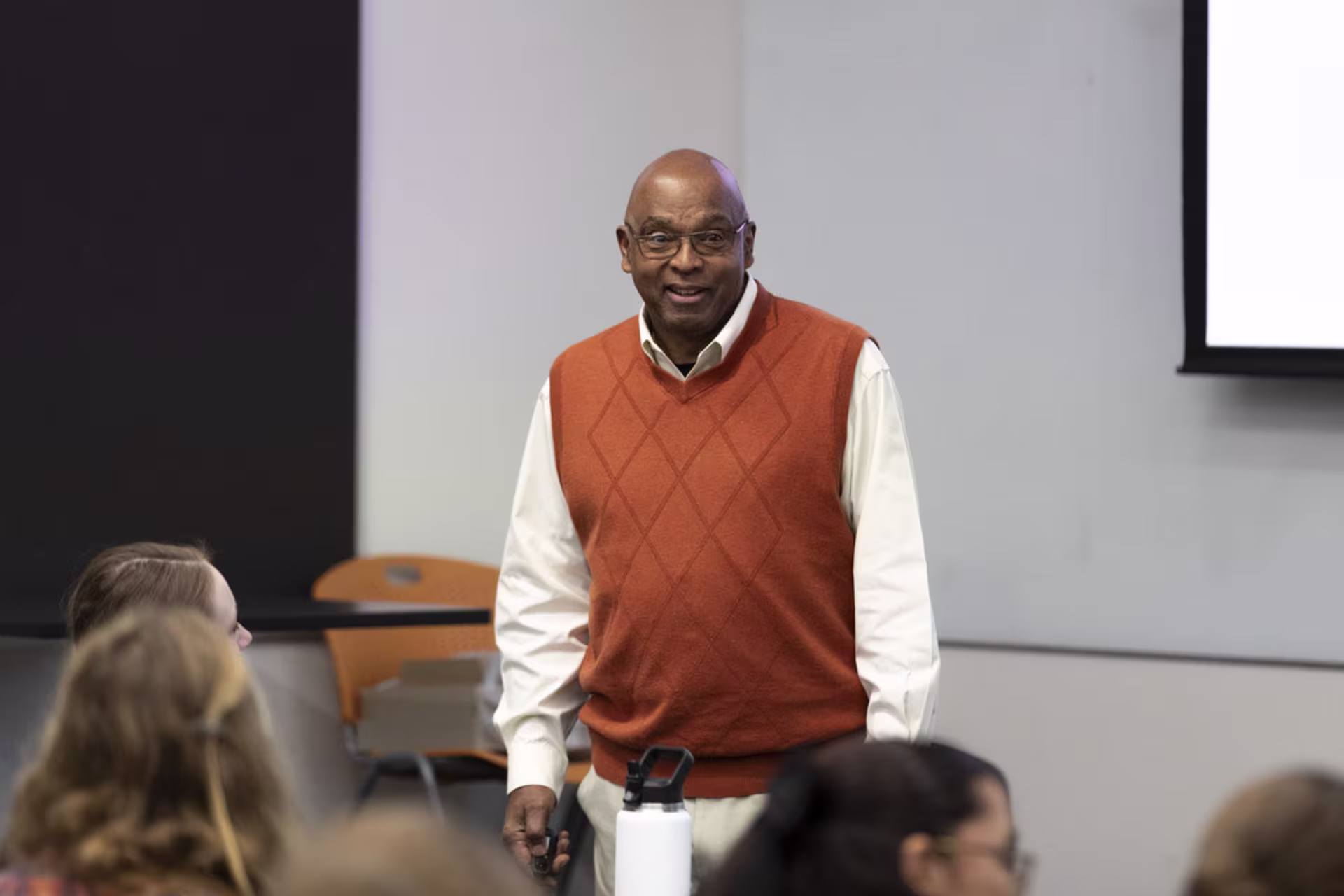 Male organizational development professional speaking in front of class