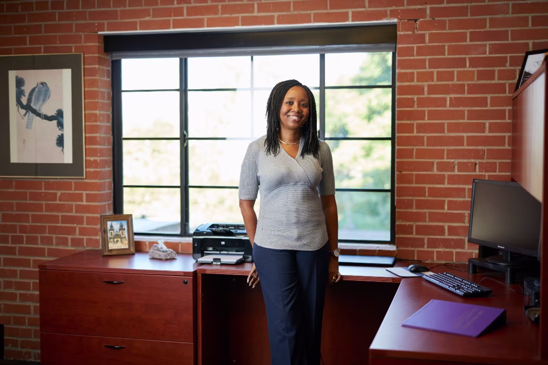 behavioral health woman standing in near desk in an office setting