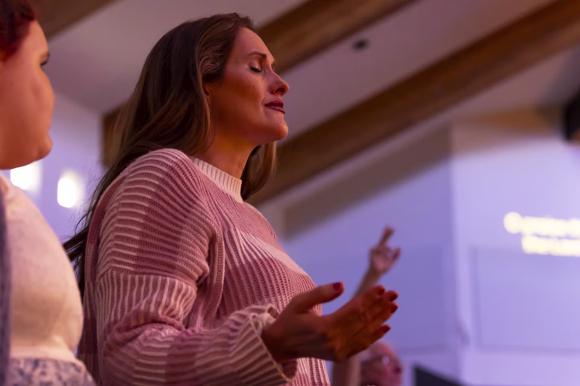 Female Christian leader worshiping with female church member