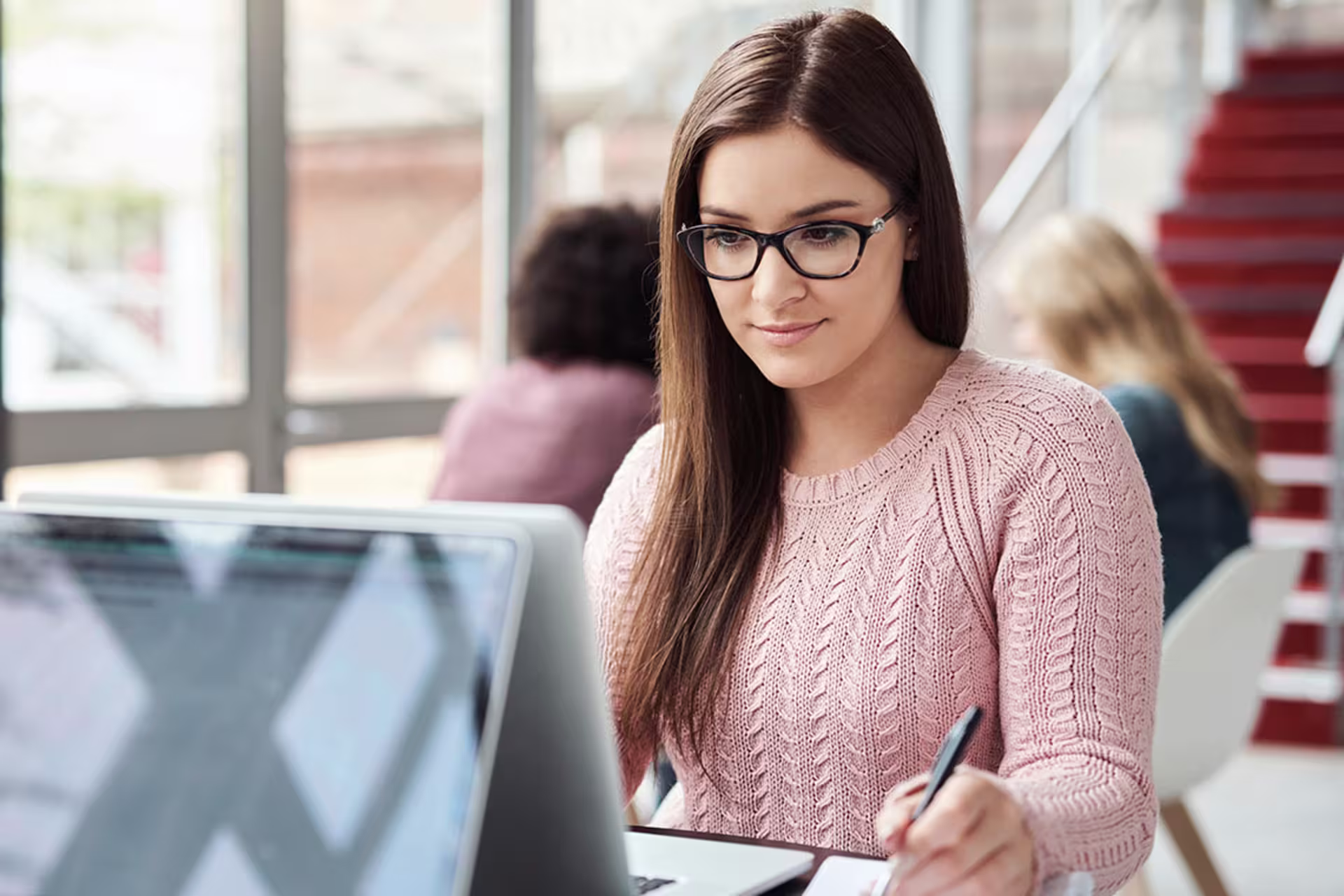 Female applied technology professional working on laptop