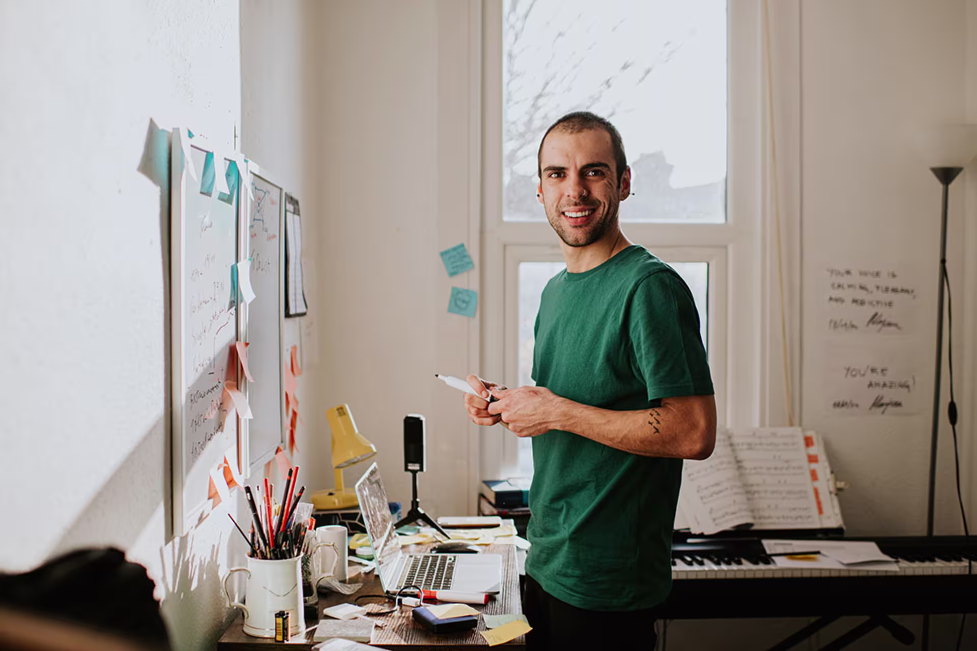 Male human factors psychology student in home office and smiling at camera