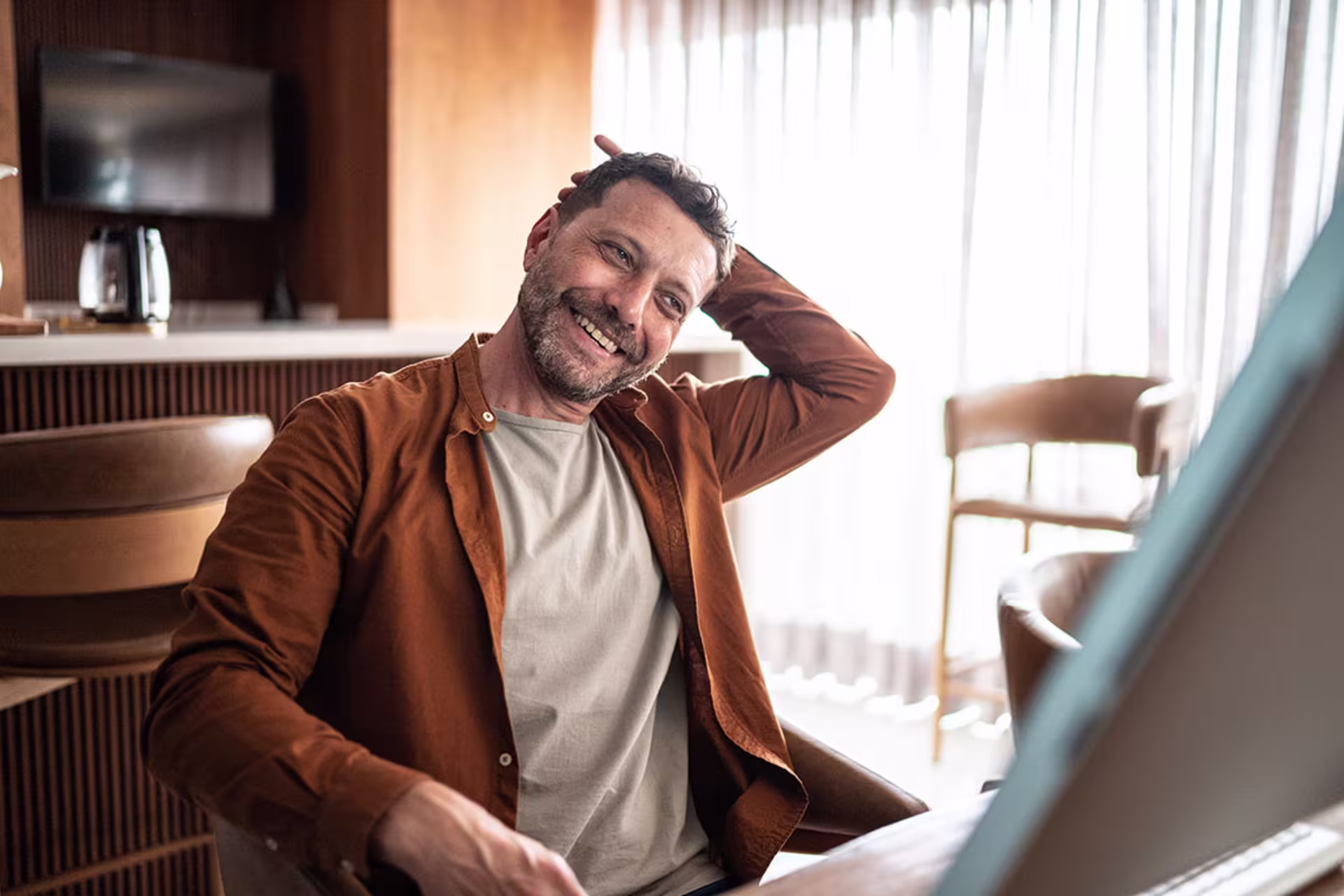 Male professional sitting at desk at home and working on computer