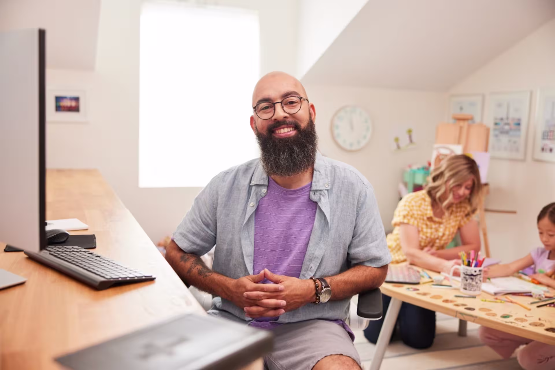 Online counseling student working from home with family in the background