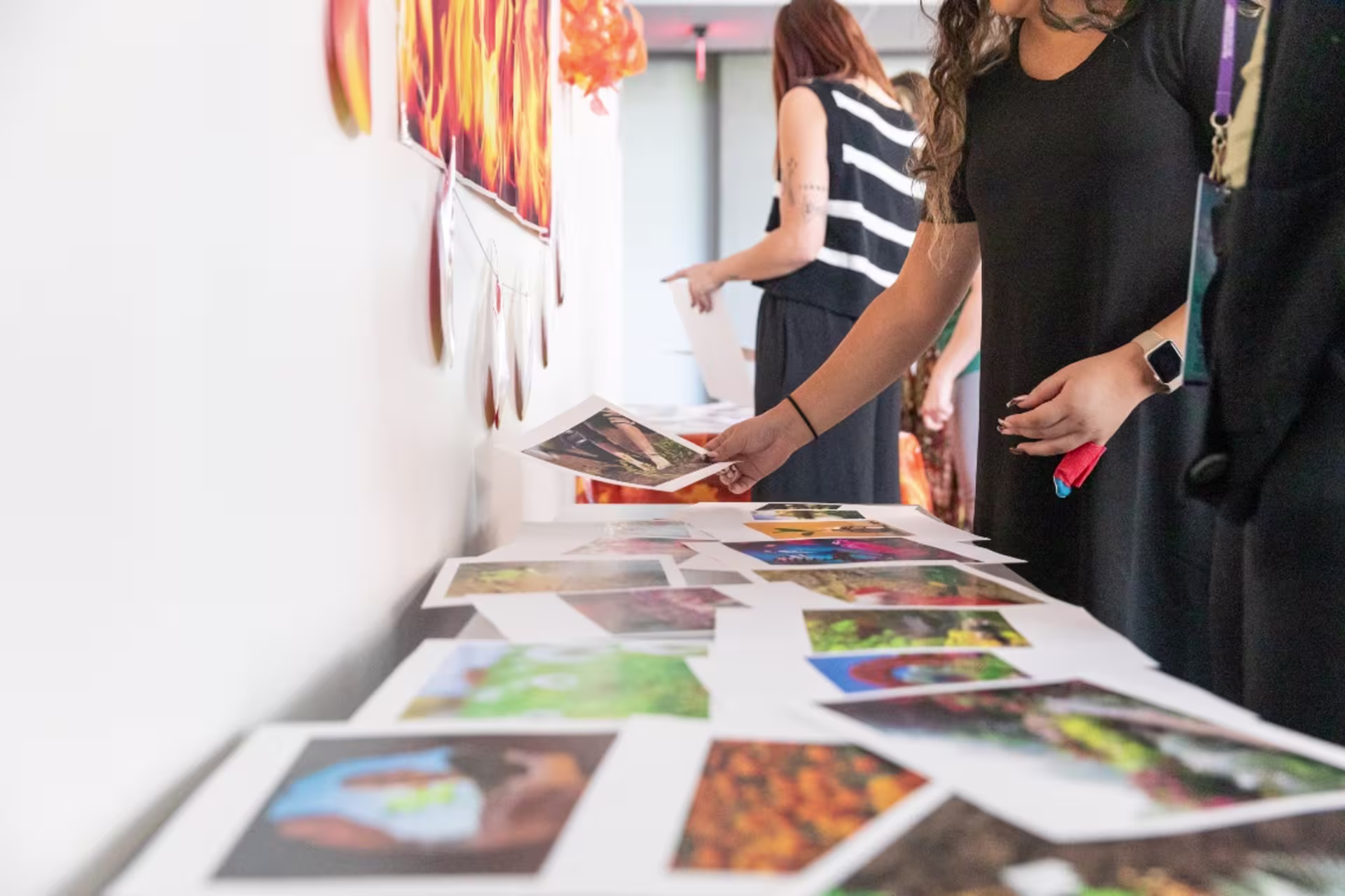 Students viewing printed out photography in a gallery setting