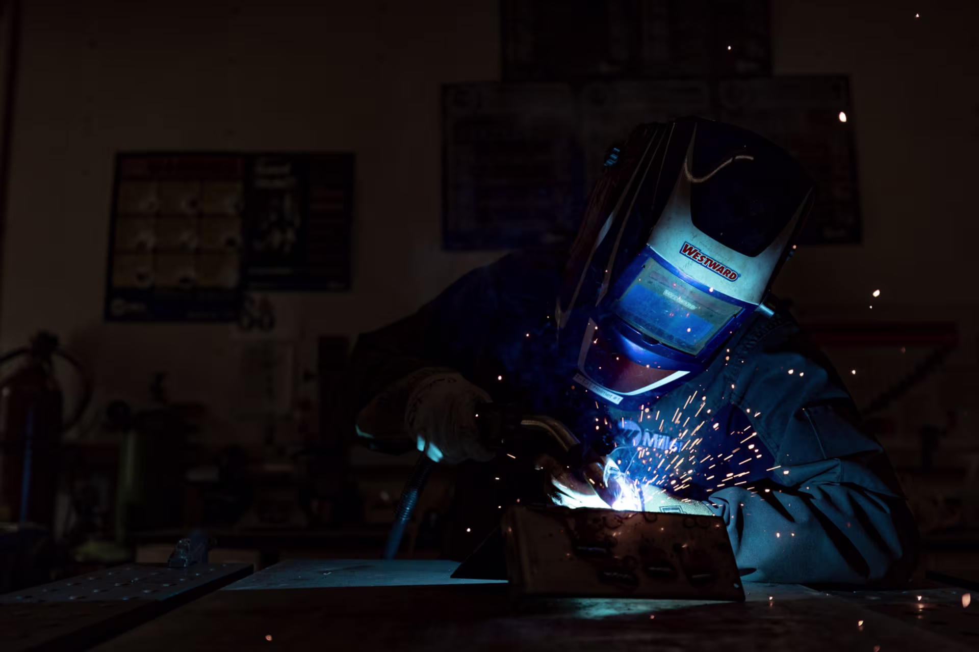 BS in MET degree student welding in lab while wearing PPE