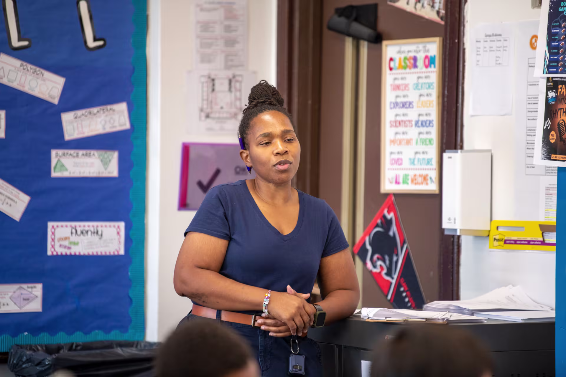 Teacher listening to student in class