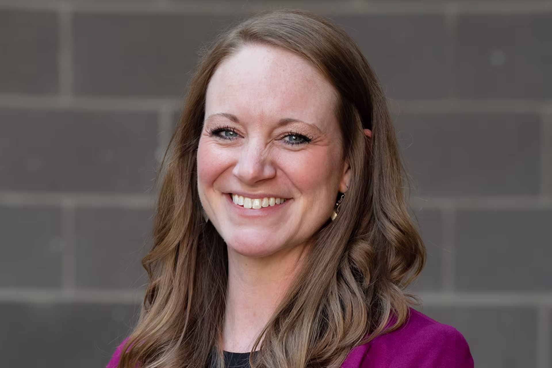 honors college director dr. hahn headshot in fuchsia blazer over black
