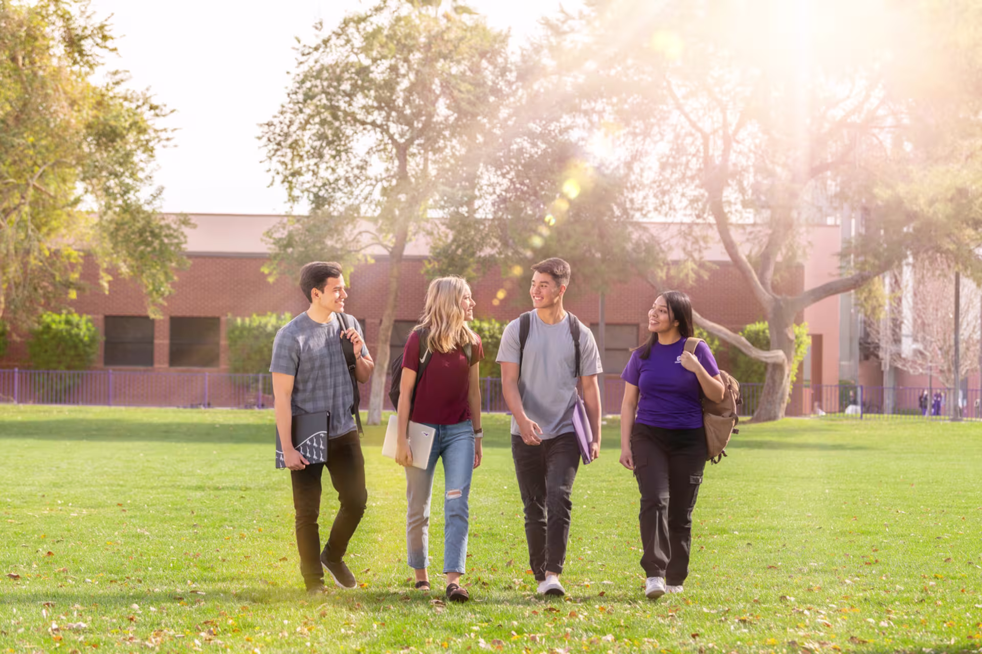Group of male and female college students walking outside