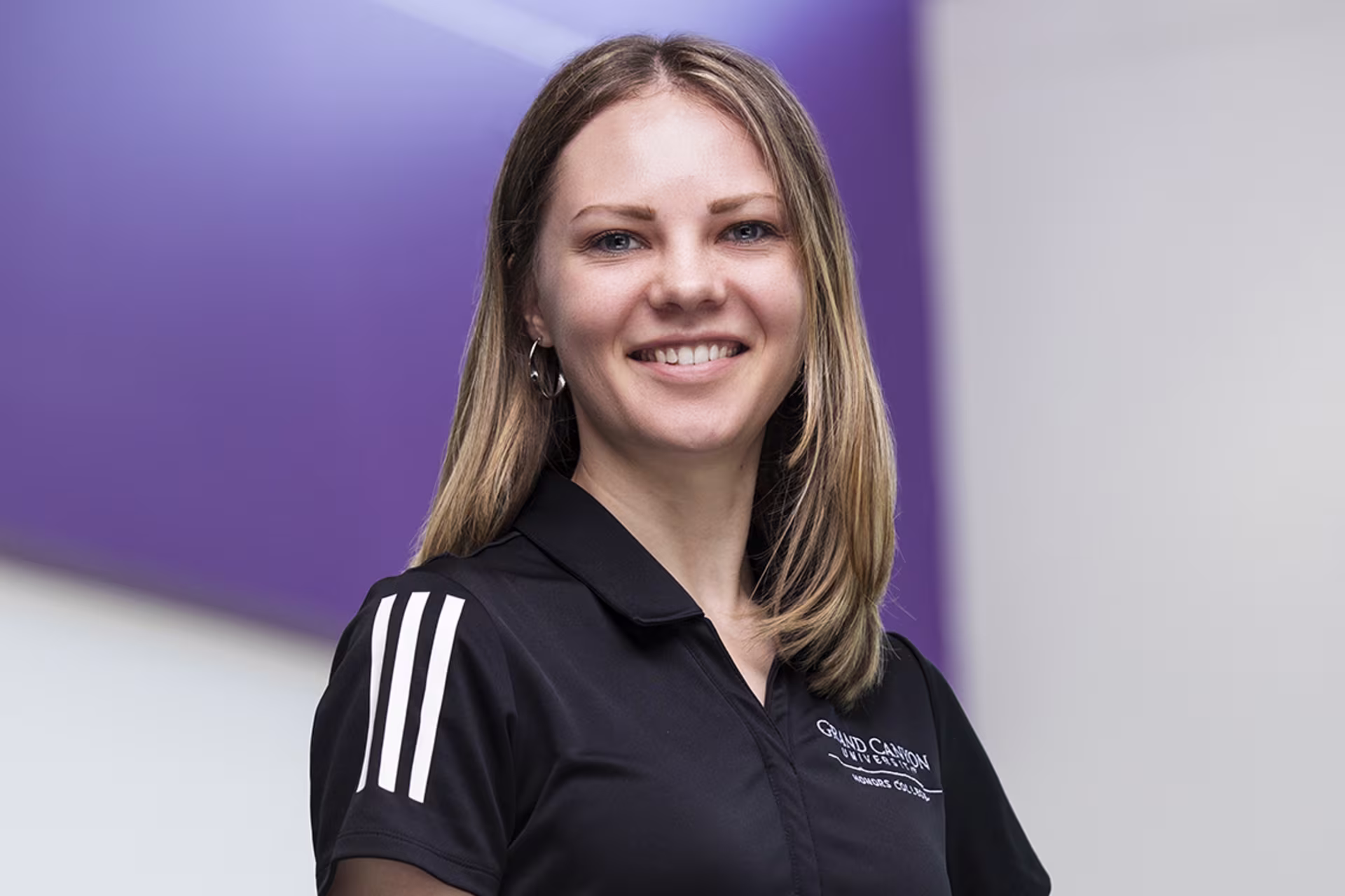 honors program manager anya cofrancesco headshot in black branded tee