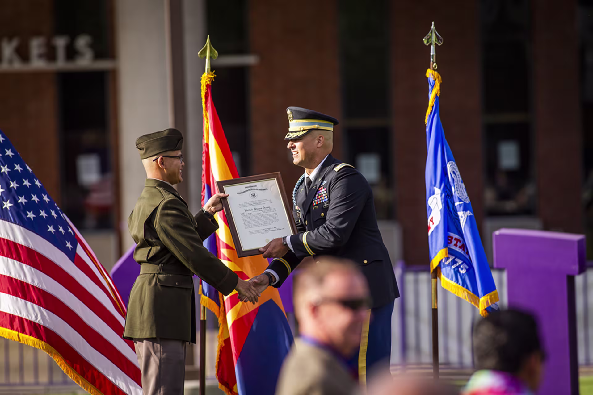 ROTC graduate on stage shaking hands
