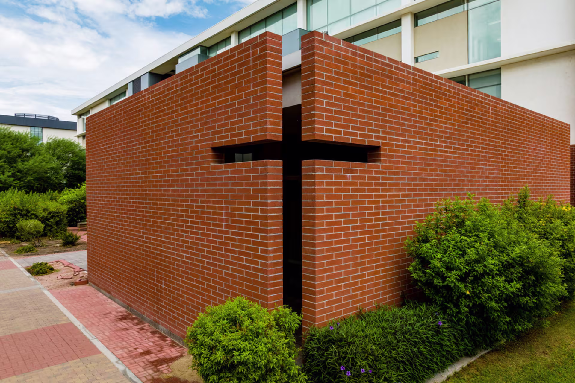 cut out of a cross shape in intersecting brick wall on exterior of a GCU campus building