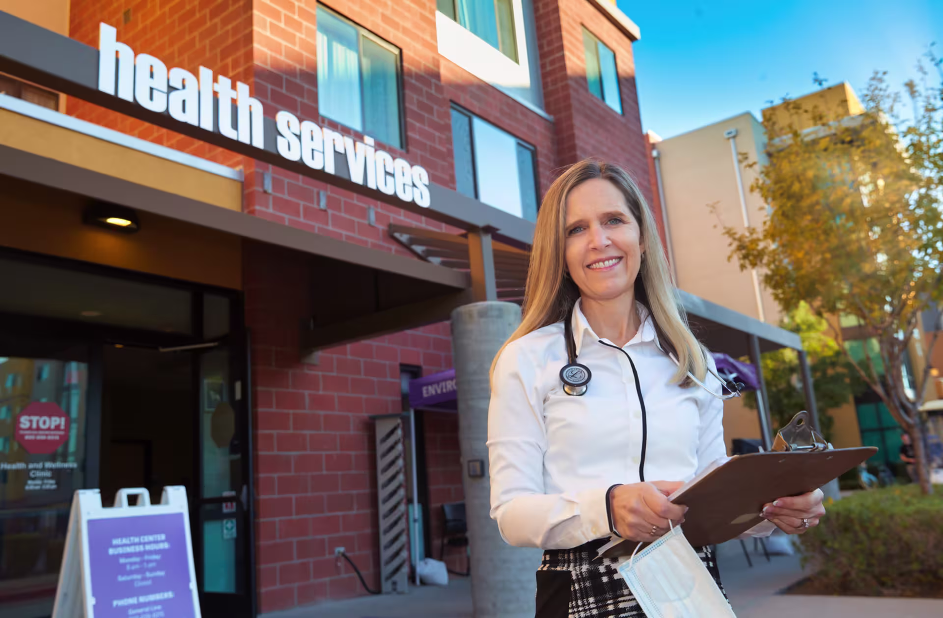 Nurse practitioner, Connie Colbert, stands in front of the health services building on GCU campus.