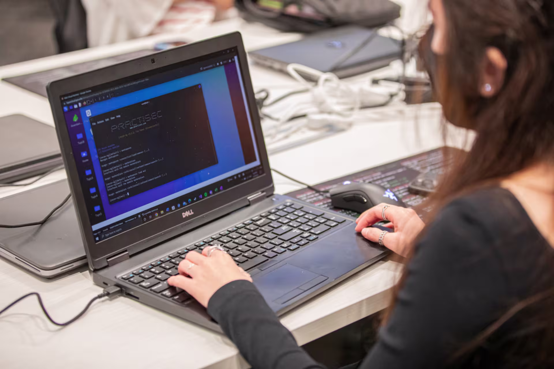 Woman hands typing on a laptop with code on the computer screen