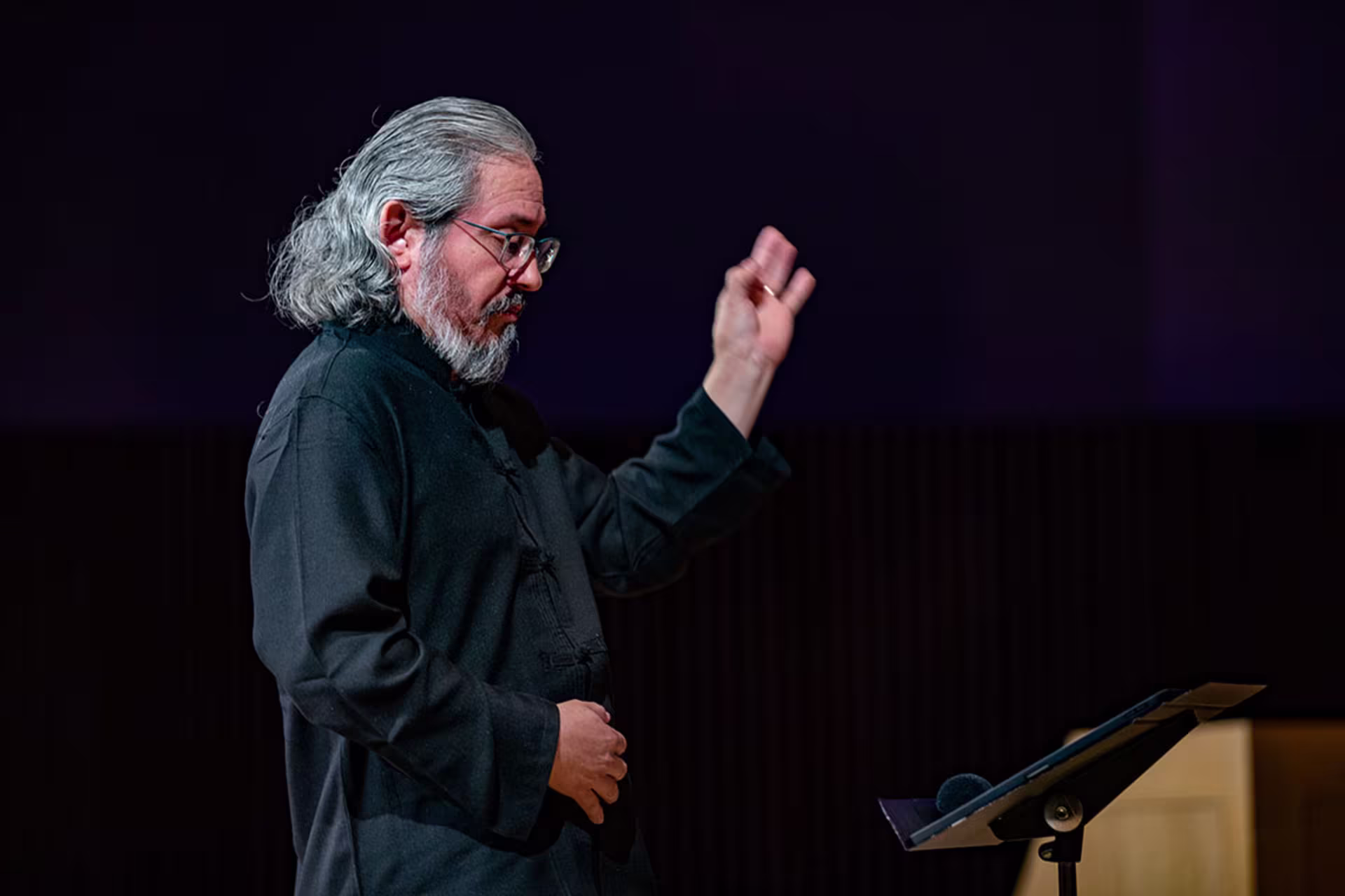 Male CAM faculty member conducting at recital