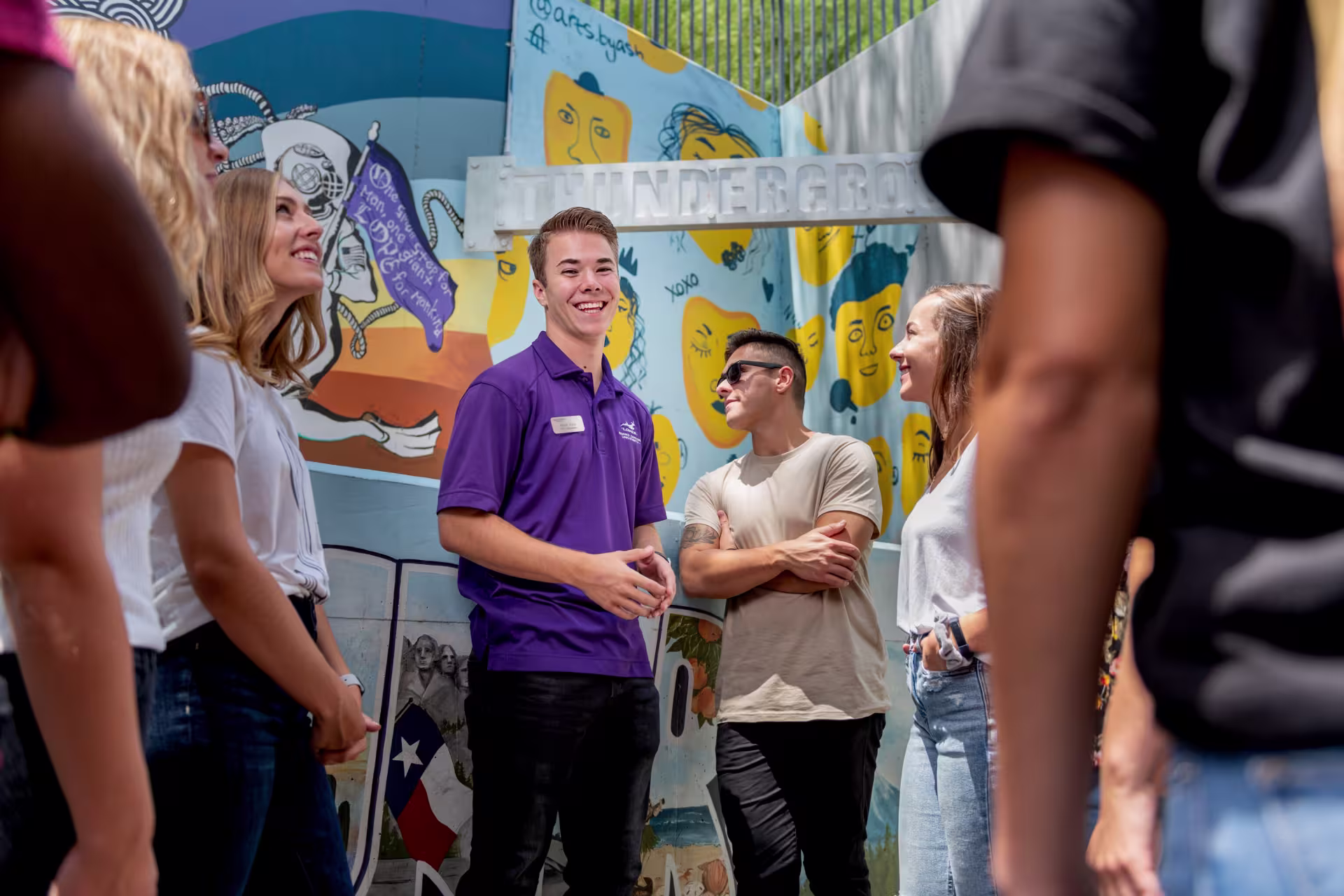 Campus tour guide smiling with group
