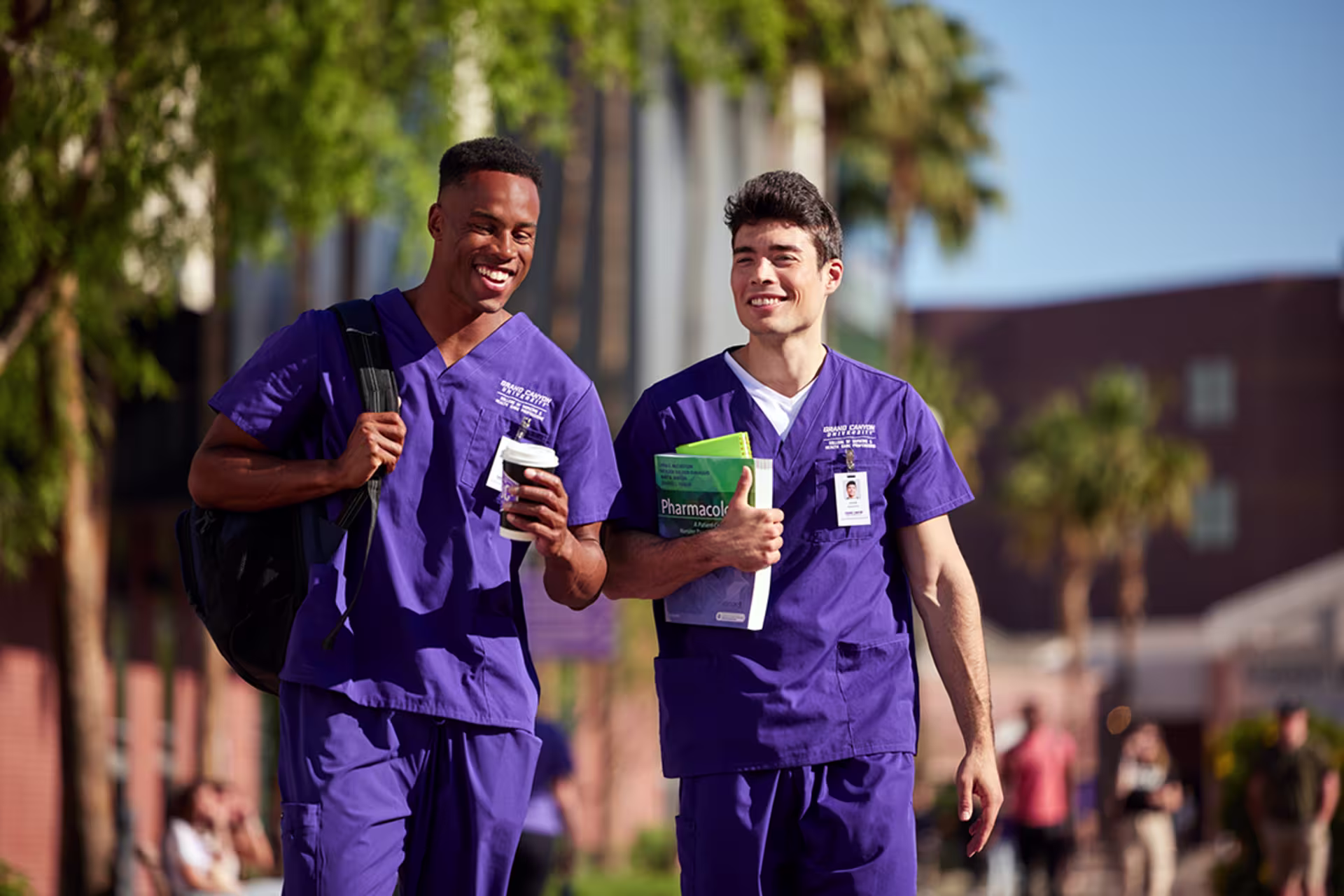 Male nursing students walking around outside of campus