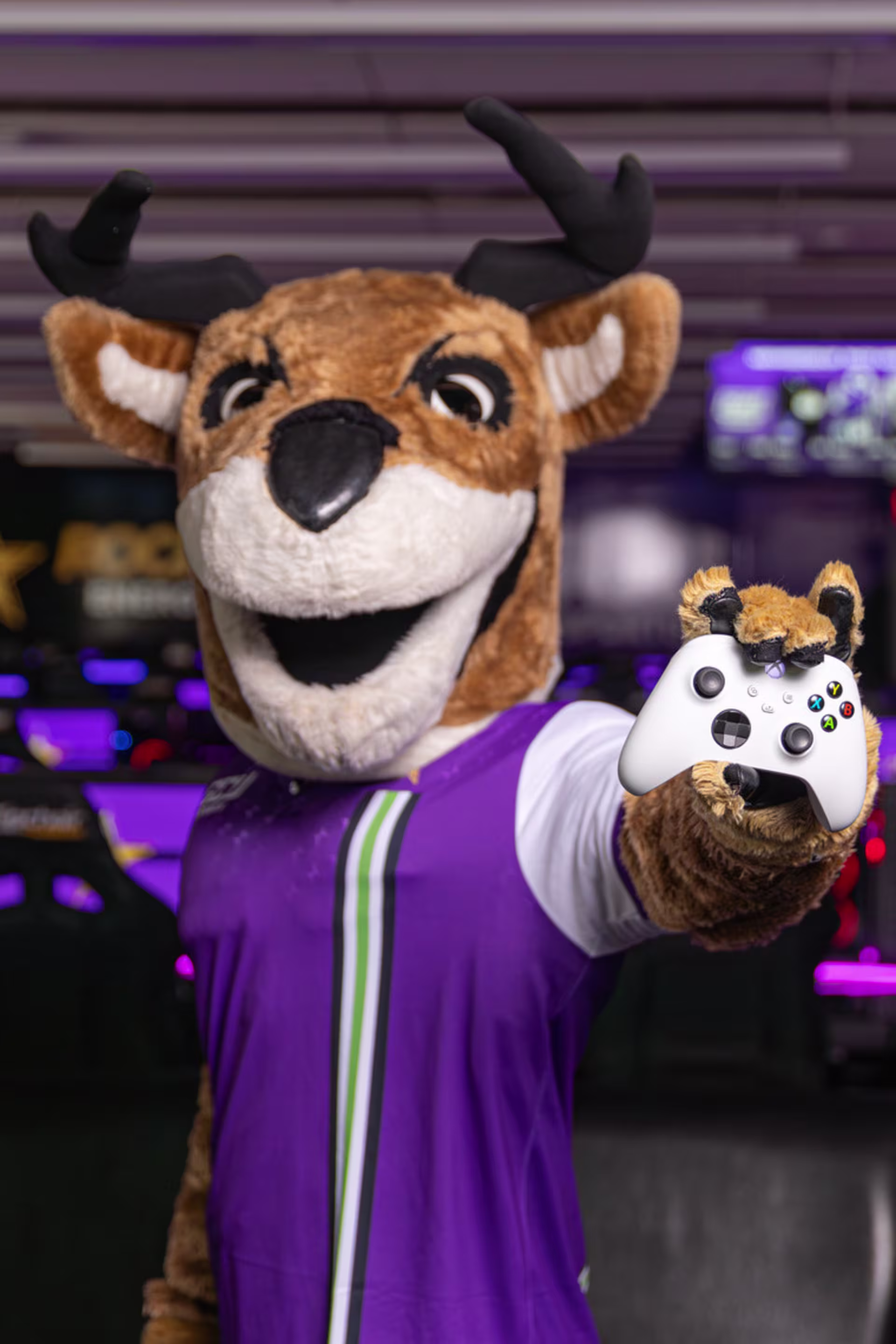 GCU's mascot Thunder holds a white controller in the esports game development and testing room