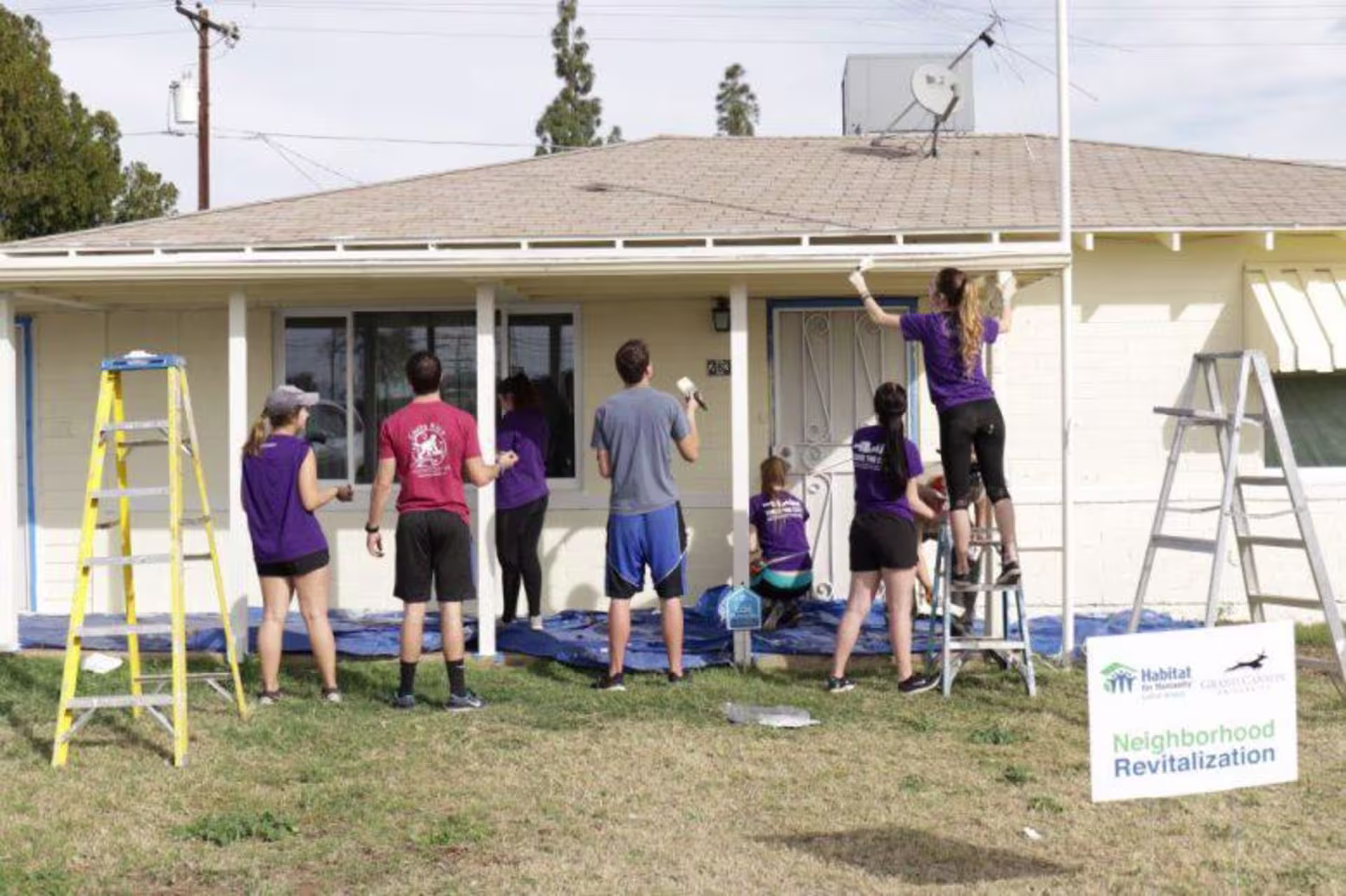A group of volunteers working on a house