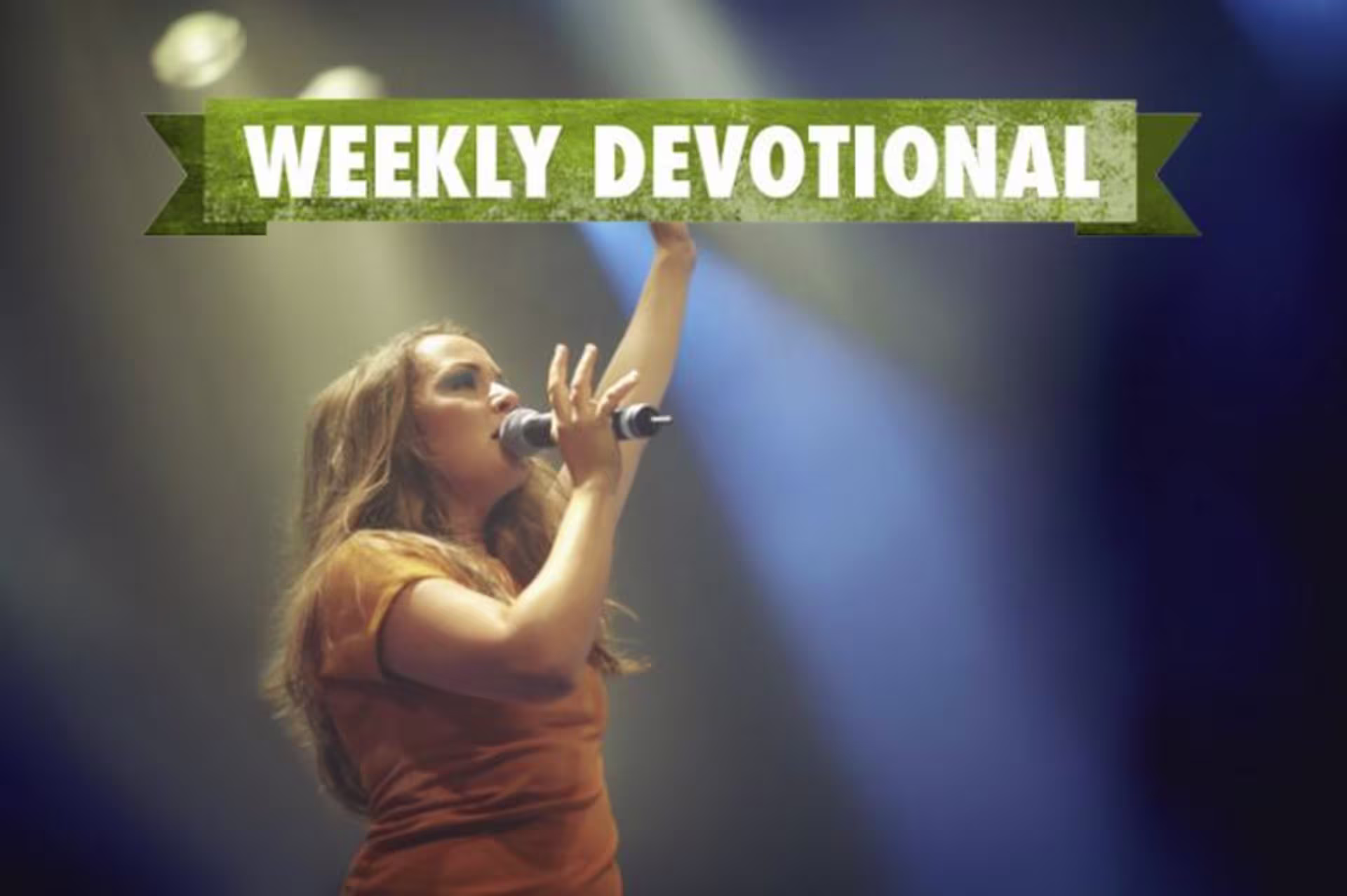 A woman singing under the Weekly Devotional banner