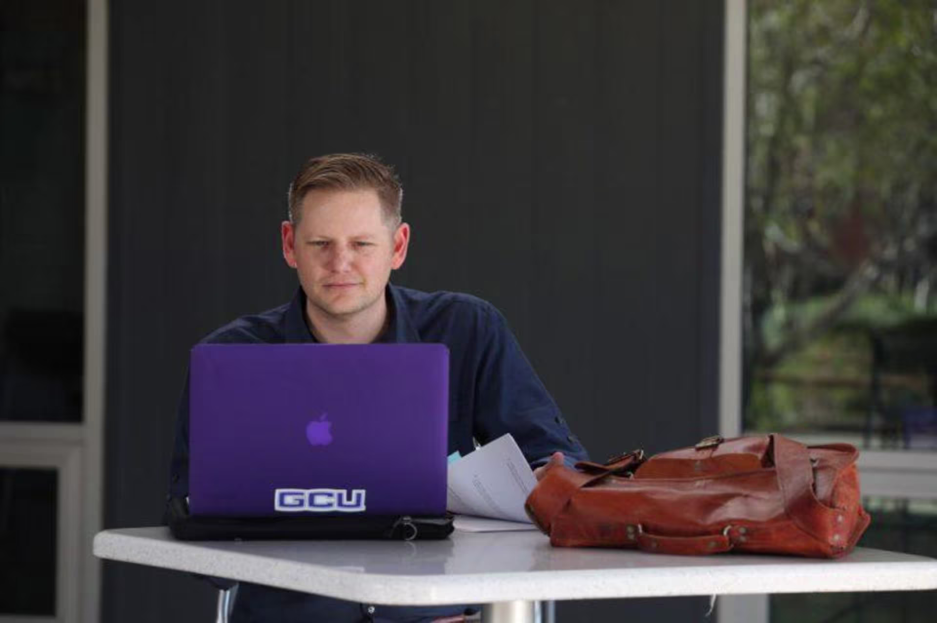 Doctoral learner working on a laptop